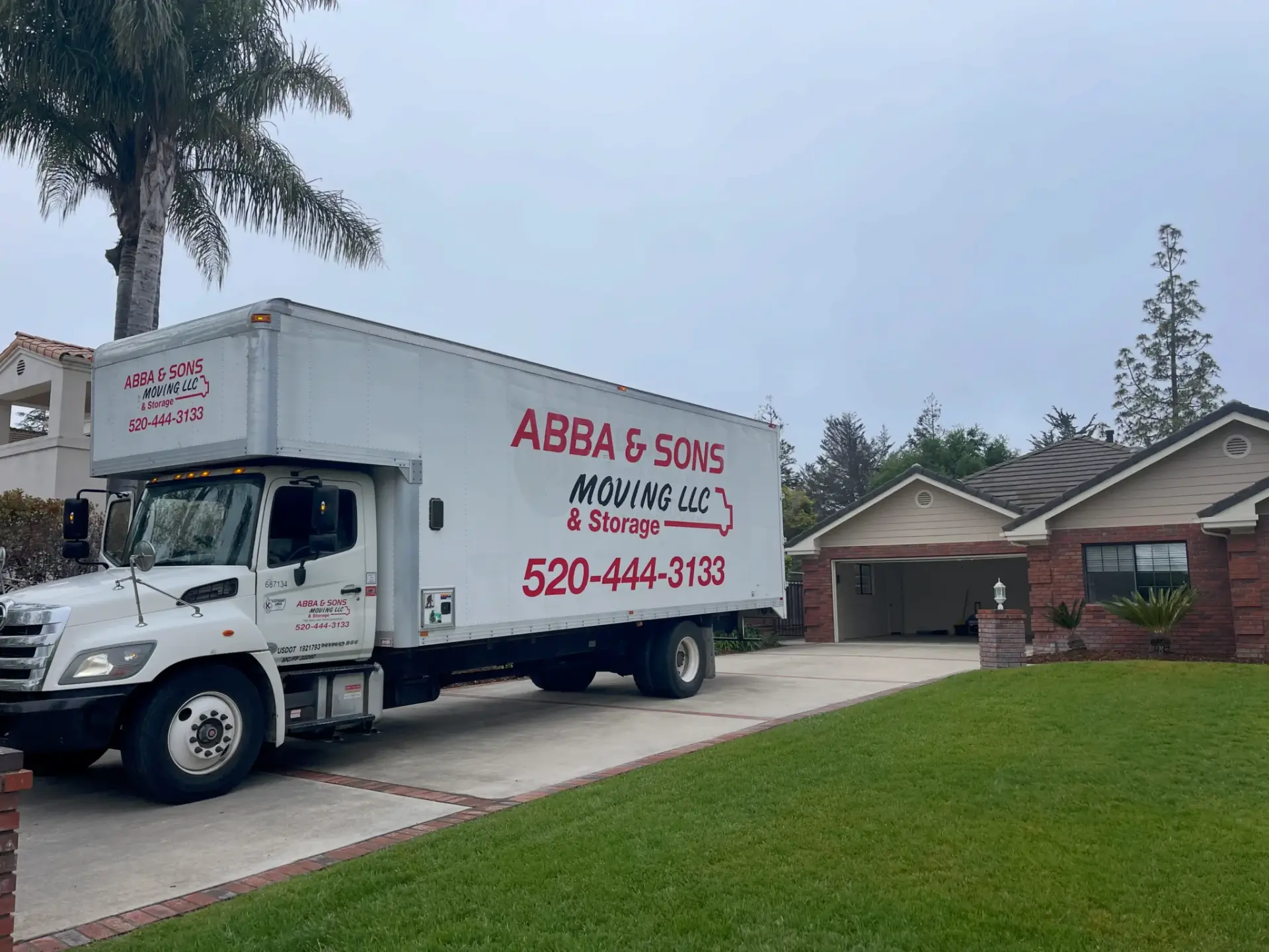 Abba and Sons Moving truck parked outside a home, ready to unload after a long-distance move