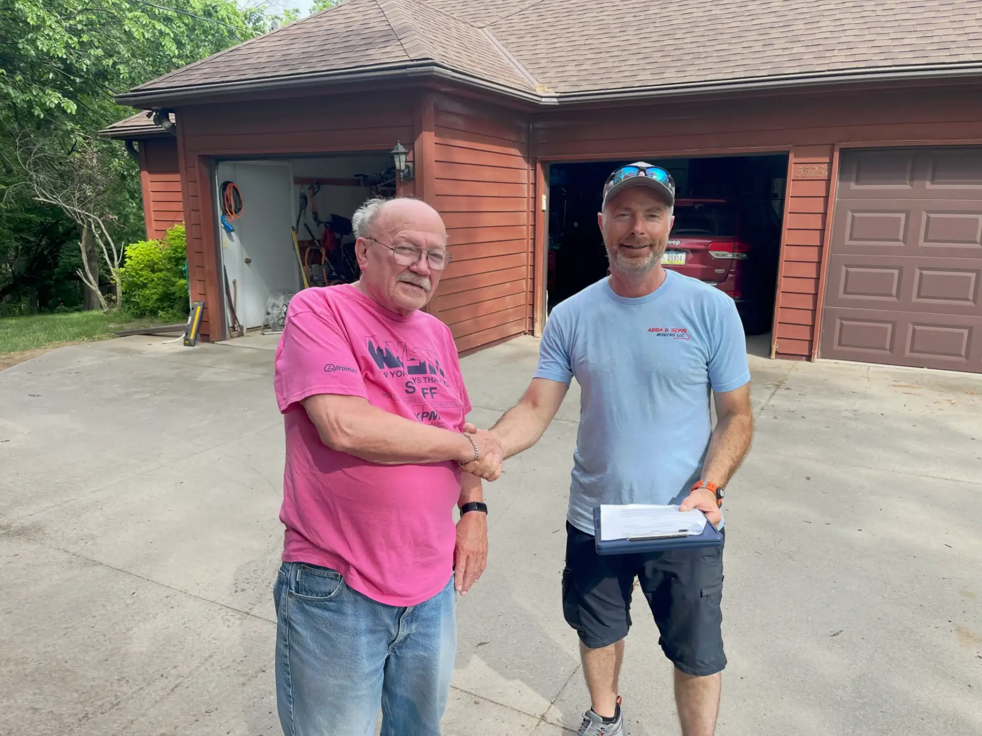 Owner of Abba and Sons Moving shaking hands with a happy customer after a successful long-distance move from Tucson