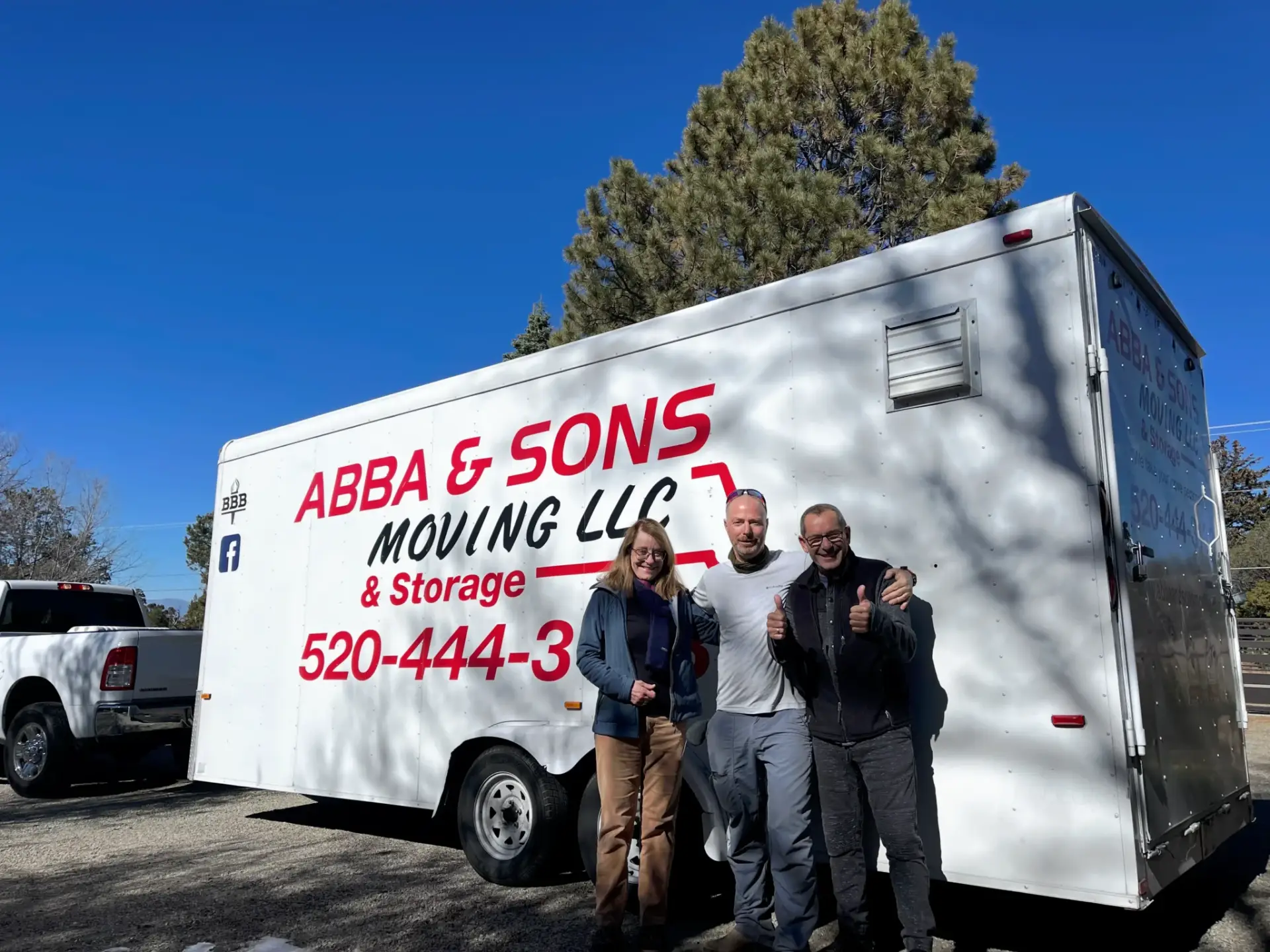 Abba and Sons Moving owner with two satisfied customers standing in front of the moving truck after a successful Tucson relocation